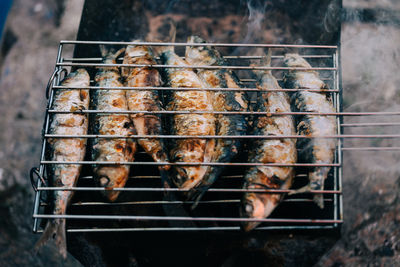 High angle view of fish being grilled on barbecue