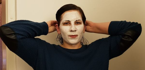 Portrait of young woman with face mask at home