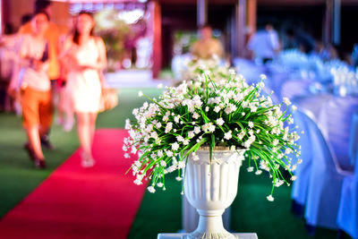 White flowers in pedestal urn