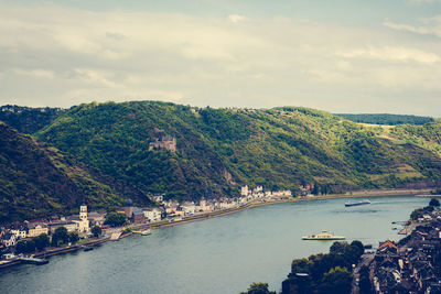 Scenic view of river and mountains against sky