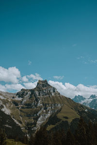 Panoramic view of landscape and mountains against blue sky