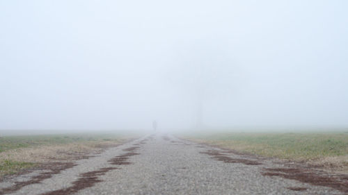 Road passing through landscape against sky