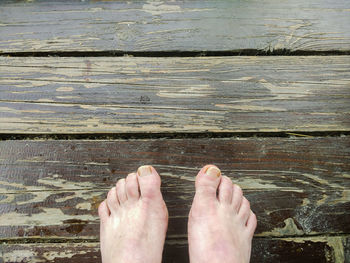 Low section of man legs on wood