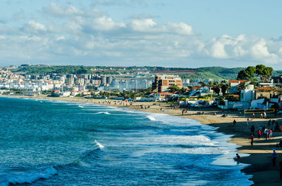 Scenic view of sea by buildings against sky