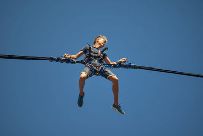 Silhouette of birds against clear blue sky