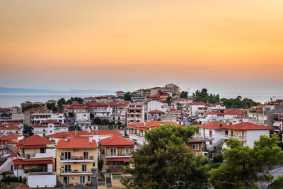 High angle view of townscape against orange sky
