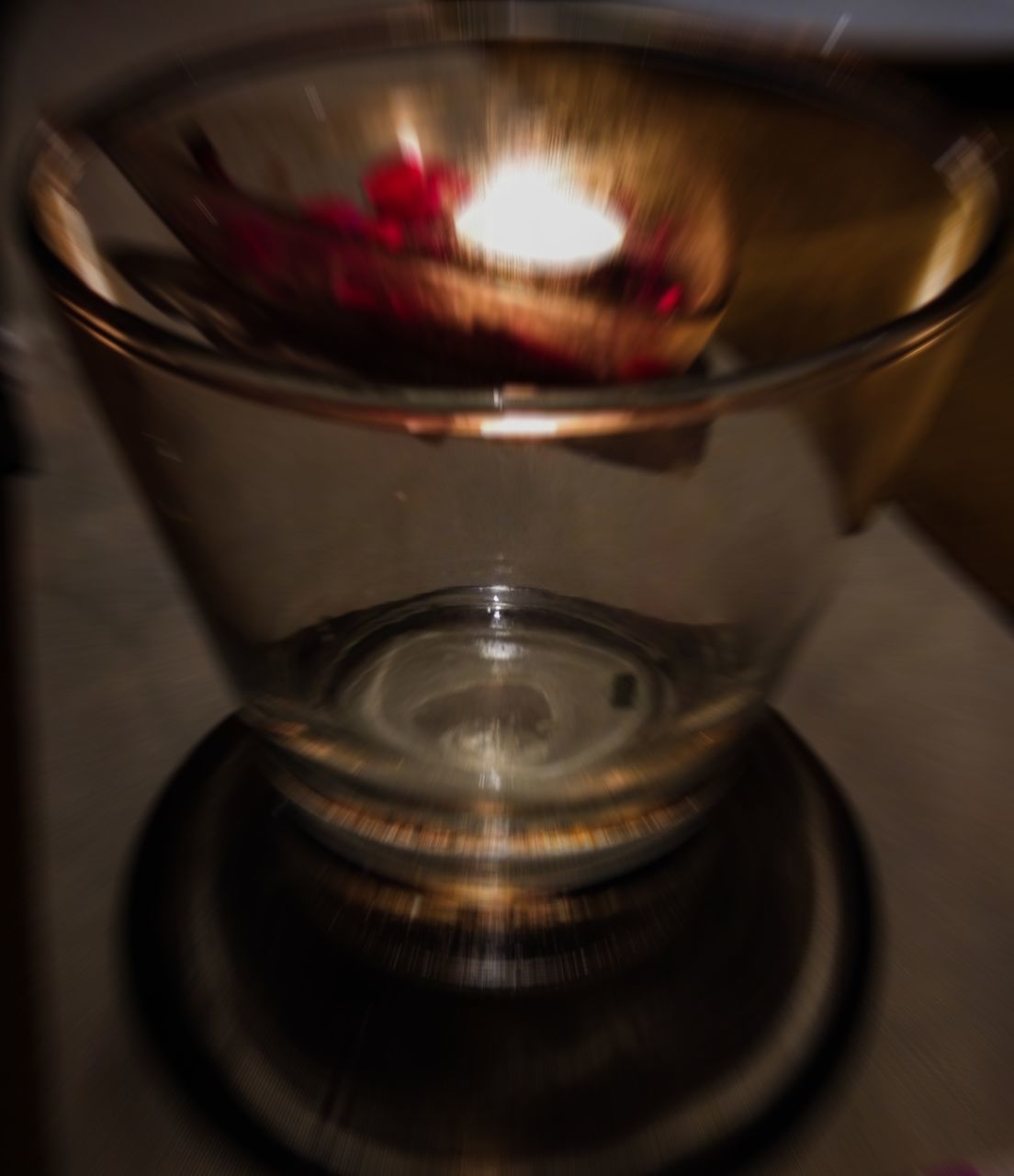 CLOSE-UP OF ILLUMINATED TEA LIGHT CANDLE