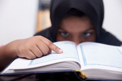 Portrait of young woman reading book