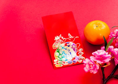 Close-up of orange flowers against red background