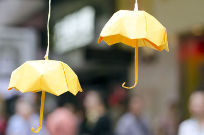 Close-up of yellow origami umbrella hanging outdoors during the umbrella revolution in hong kong