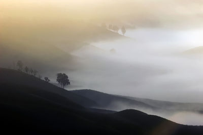 Scenic view of silhouette mountains against sky during sunset