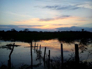 Scenic view of lake at sunset
