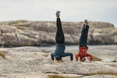 Mother and daughter doing handstand