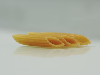 Close-up of yellow cake against white background