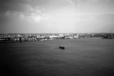 Scenic view of sea by city against sky