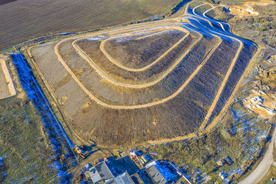 Aerial top view of a city garbage dump. waste disposal facility