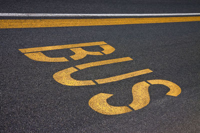 High angle view of yellow sign on road