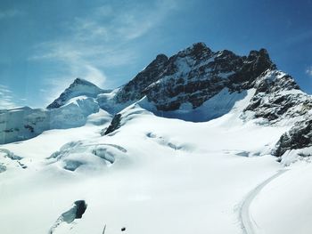 Scenic view of snowcapped mountains against sky