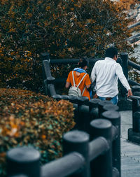 Rear view of man and plants during autumn