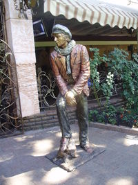 Man standing statue against built structure