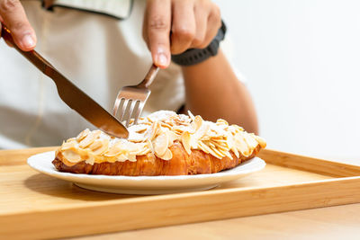 Cropped hand of person preparing food on cutting board