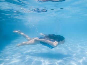 High angle view of woman swimming in sea