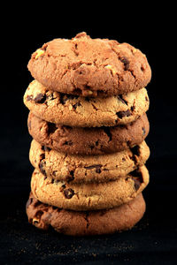 Stack of cookies against black background