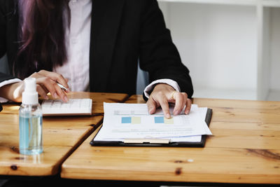 Midsection of woman working on table