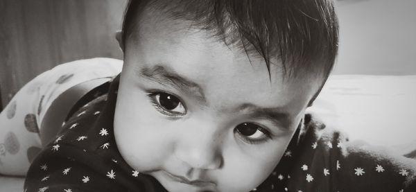 Close-up of cute baby girl looking away