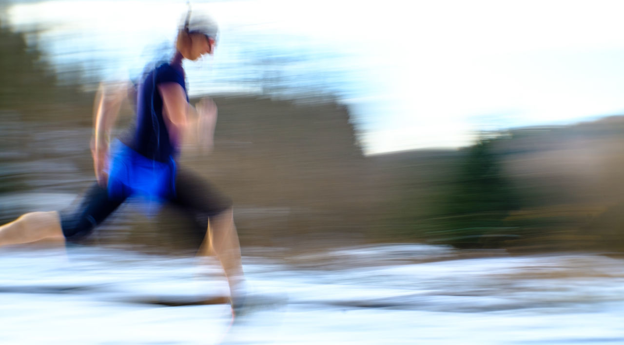BLURRED MOTION OF MAN RUNNING AT WATER