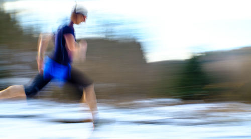 Blurred motion of man running on water