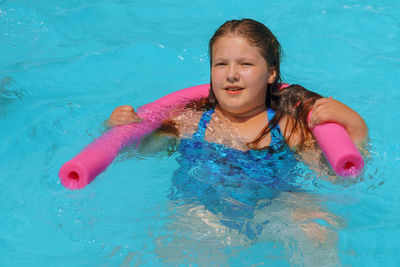 High angle portrait of girl in swimming pool