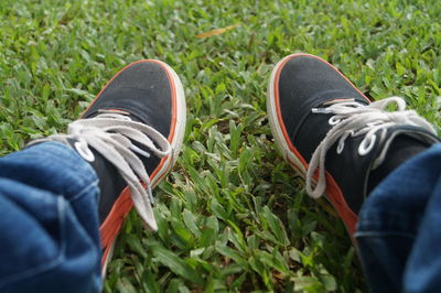 Low section of man sitting on grass