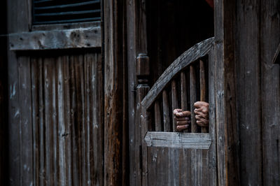 Close-up of hand on closed door