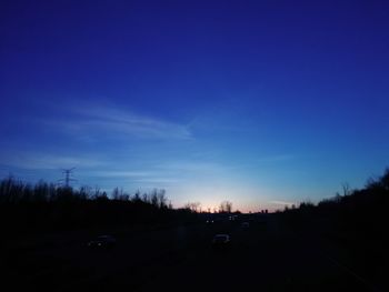 Cars on road at sunset