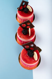 High angle view of strawberries on glass table against white background