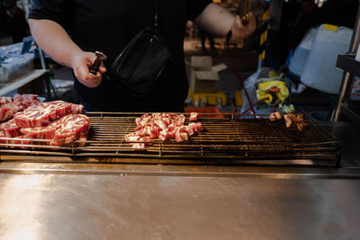 Man preparing food on barbecue grill