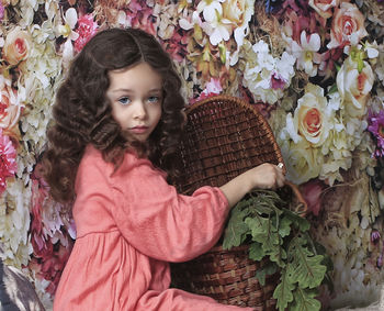 Portrait of cute girl with pink flowers