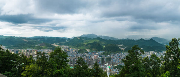 Panoramic view of trees and mountains against sky