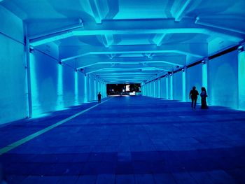 People walking in subway tunnel