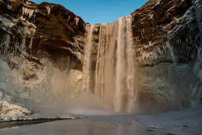 Scenic view of waterfall against clear sky