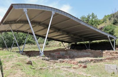 Metallic structure on field against sky