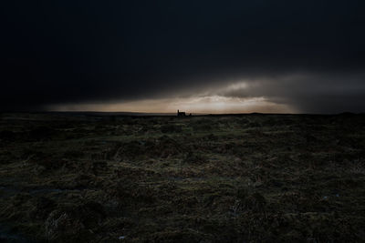 Scenic view of field against sky at dusk