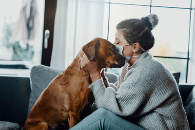 Man with dog sitting at home
