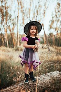 Portrait of a girl standing on field