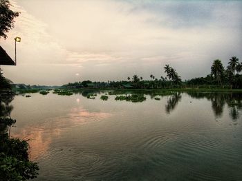 Scenic view of lake against sky at sunset