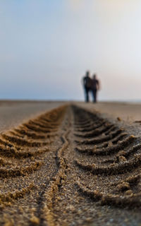 Surface level of water on beach against sky