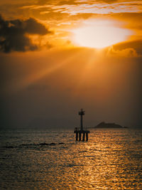 Silhouette boat in sea against sky during sunset