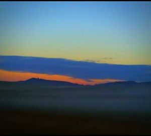 Scenic view of mountains against sky during sunset