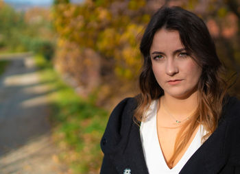 Portrait of beautiful young woman standing outdoors